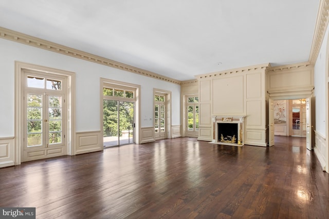 unfurnished living room featuring dark hardwood / wood-style flooring and a healthy amount of sunlight