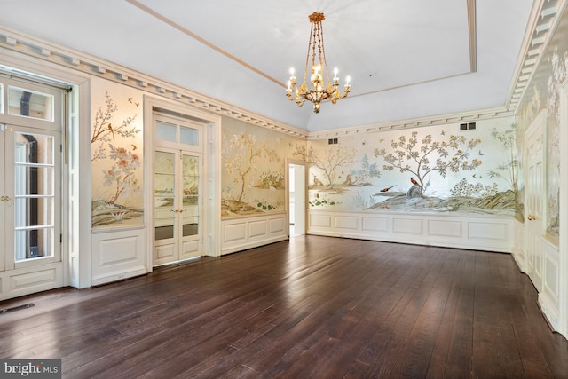 unfurnished room featuring a chandelier and dark wood-type flooring