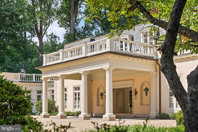 back of property featuring a balcony