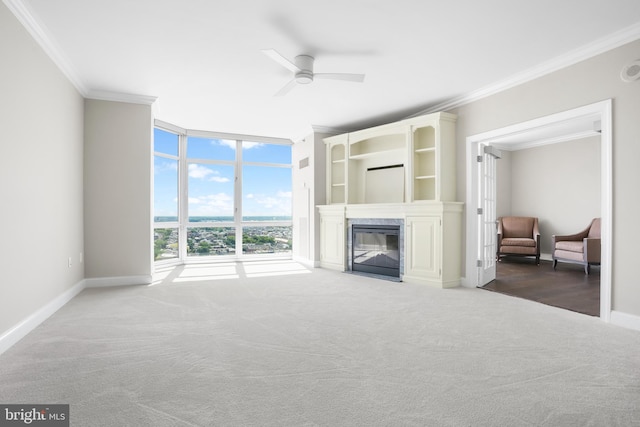 living area featuring baseboards, ornamental molding, carpet flooring, and floor to ceiling windows