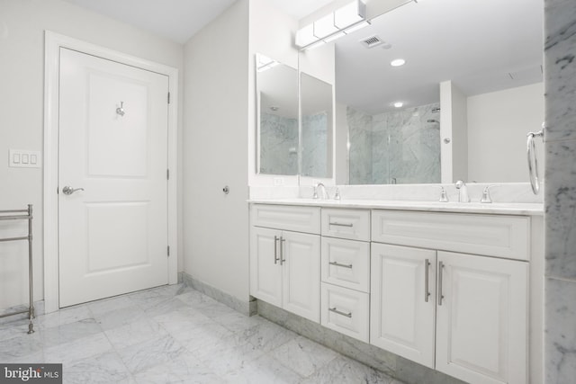 full bath with a sink, visible vents, marble finish floor, a marble finish shower, and double vanity