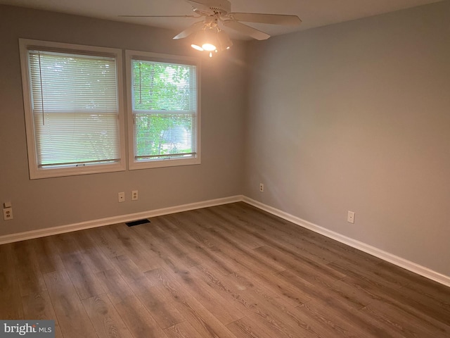 unfurnished room with hardwood / wood-style flooring and ceiling fan