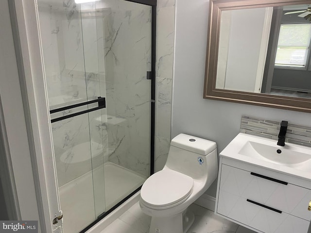 bathroom with vanity, tasteful backsplash, toilet, and a shower with door