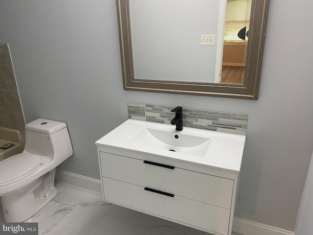 bathroom featuring decorative backsplash, toilet, and vanity