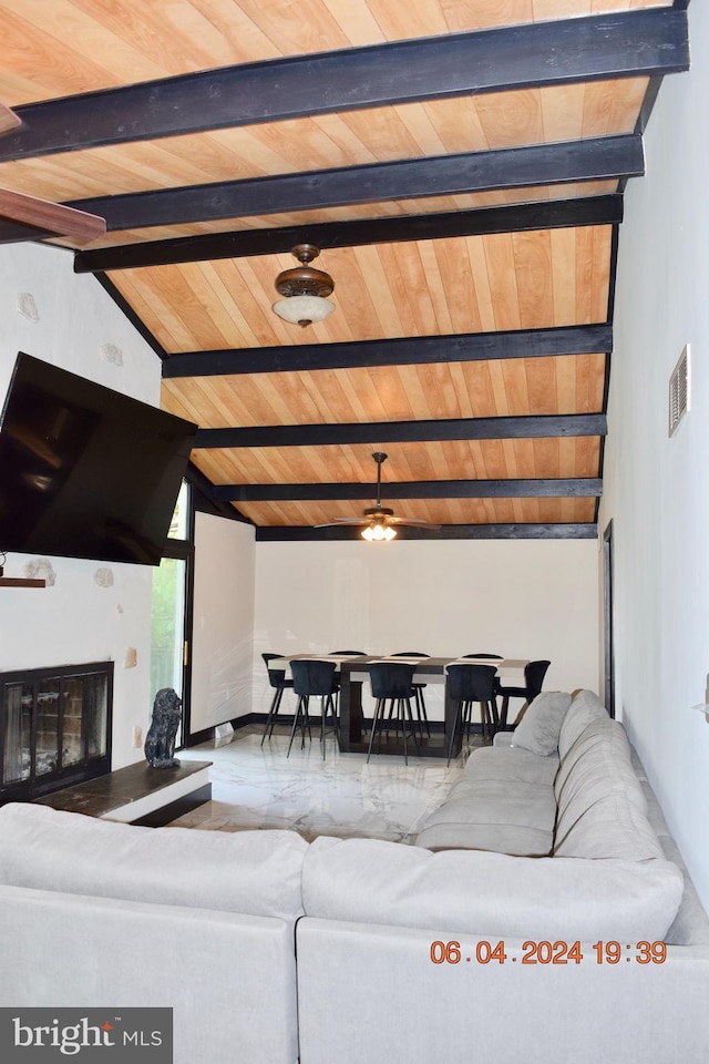 living room with vaulted ceiling with beams, ceiling fan, and wooden ceiling