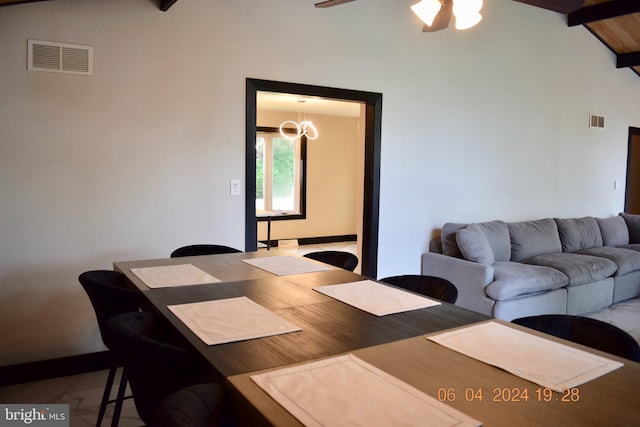 dining area featuring vaulted ceiling with beams and ceiling fan with notable chandelier