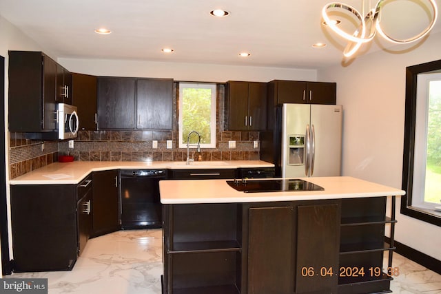 kitchen featuring sink, a healthy amount of sunlight, and black appliances