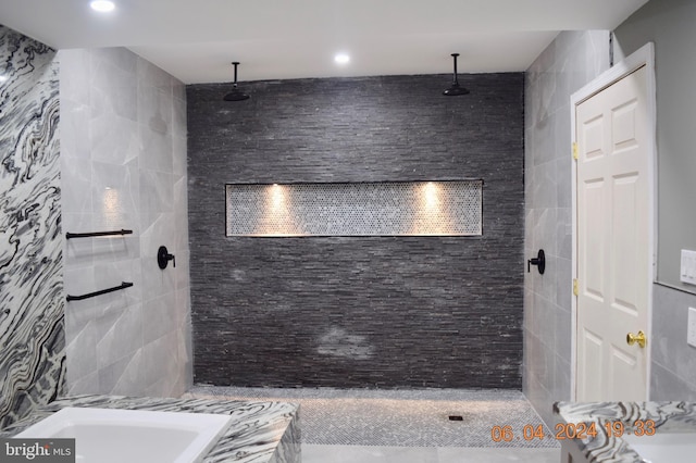 bathroom featuring tiled shower and tile walls