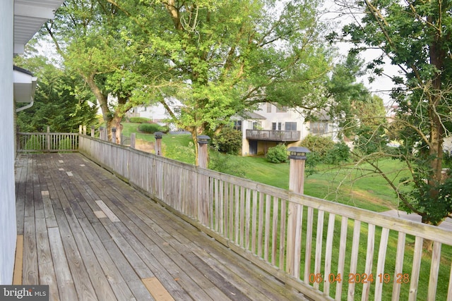 wooden deck with a lawn