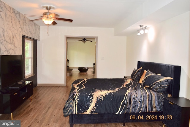 bedroom featuring ceiling fan and hardwood / wood-style flooring