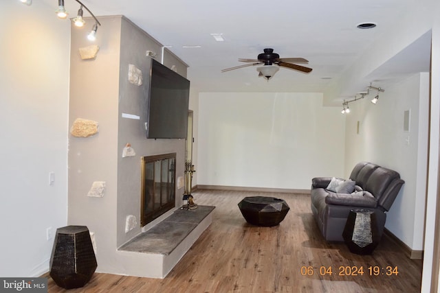 living room with ceiling fan and light wood-type flooring