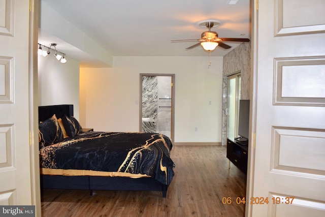 bedroom with hardwood / wood-style floors, ensuite bath, and ceiling fan