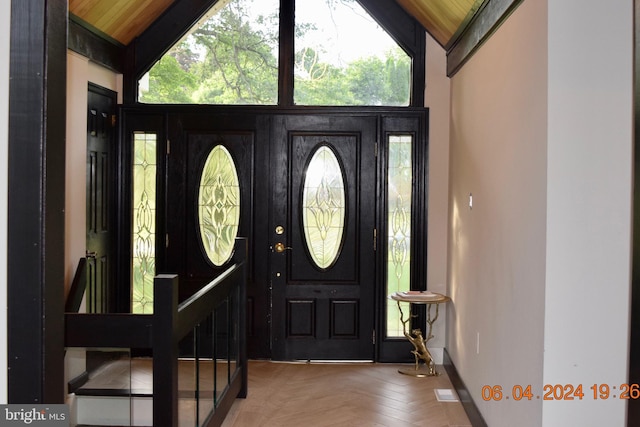 entryway featuring vaulted ceiling, parquet floors, and wooden ceiling