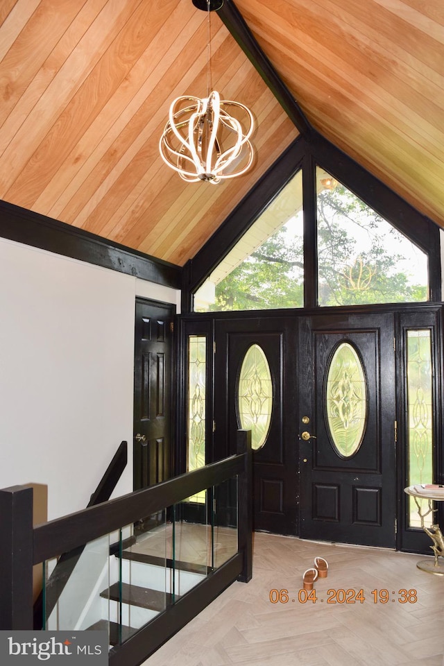 entrance foyer with light parquet floors, wooden ceiling, vaulted ceiling, and a notable chandelier