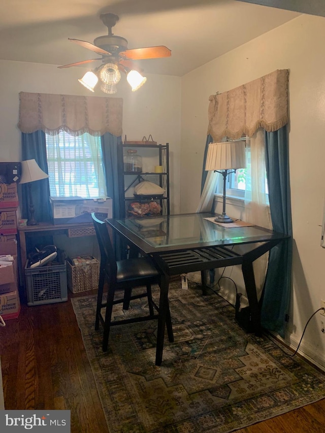 dining room featuring ceiling fan and dark wood-type flooring