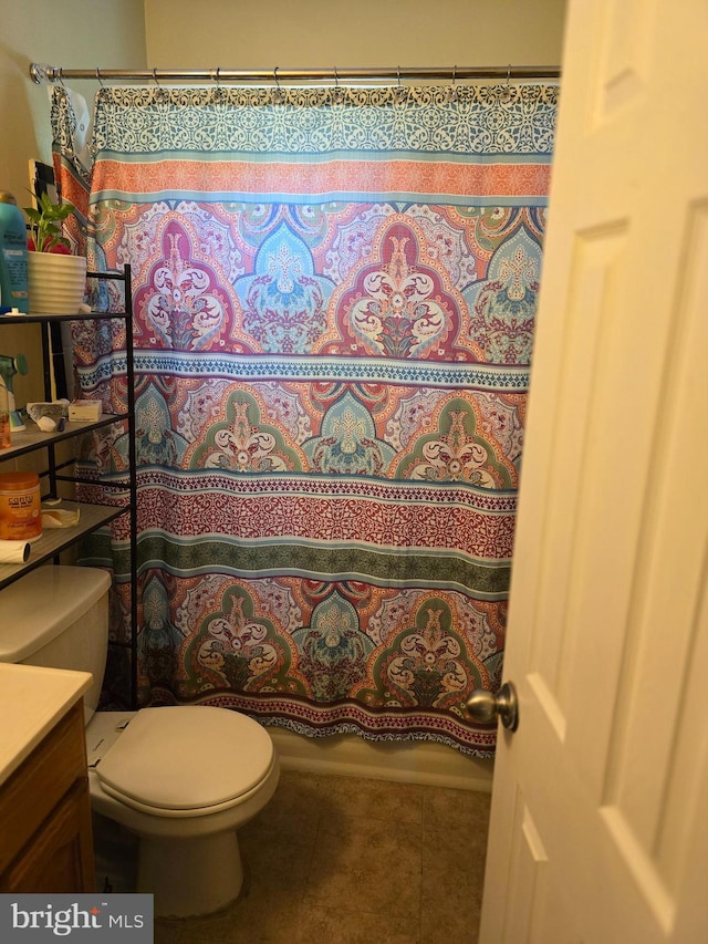 bathroom with tile patterned flooring, vanity, toilet, and a shower with curtain