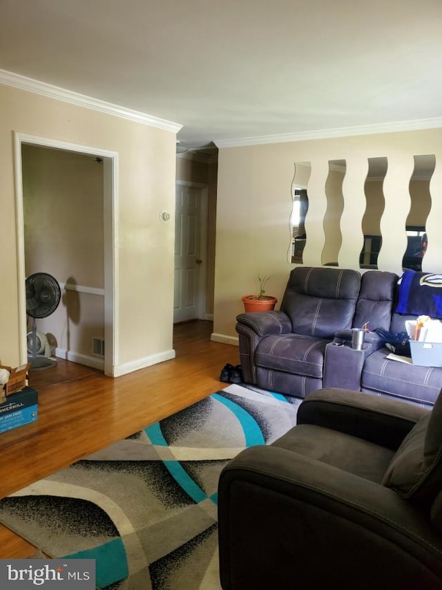 living room with wood-type flooring and crown molding