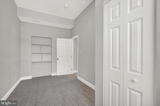 unfurnished bedroom featuring carpet flooring and a closet