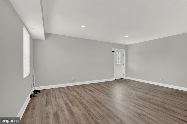 unfurnished room with wood-type flooring