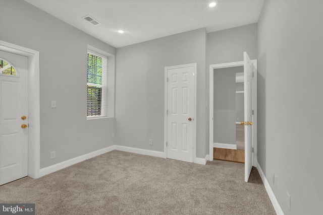 unfurnished bedroom featuring light carpet