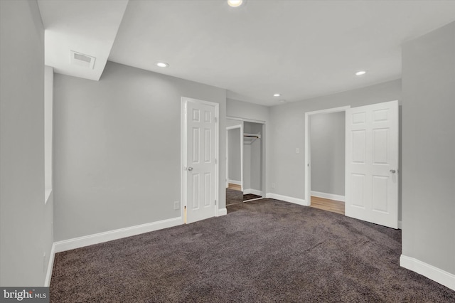 unfurnished bedroom featuring dark carpet