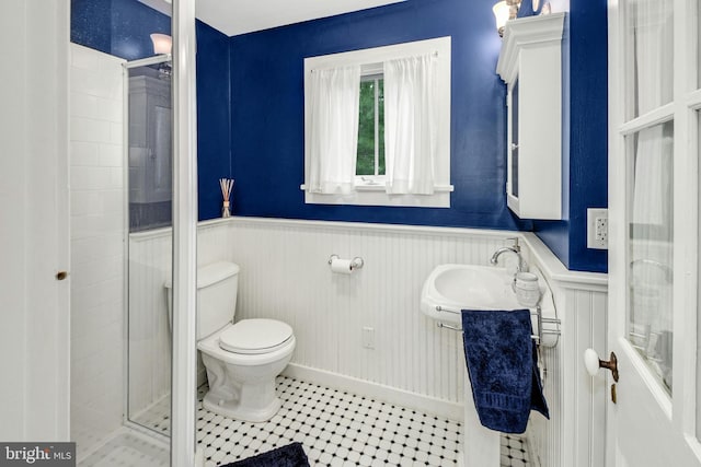 bathroom featuring walk in shower, sink, and toilet