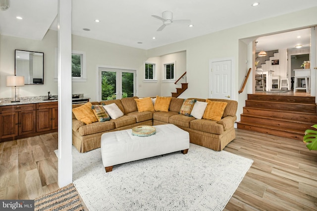 living room featuring ceiling fan, french doors, and light hardwood / wood-style flooring