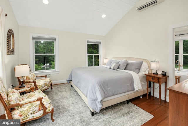 bedroom featuring wood-type flooring, lofted ceiling, an AC wall unit, and multiple windows