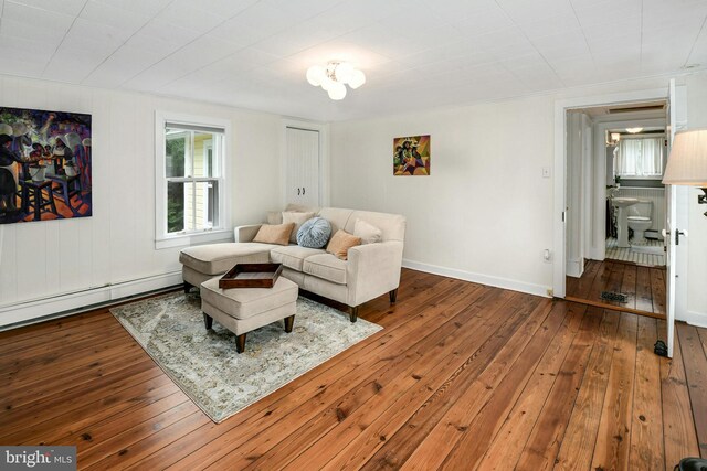 living room featuring hardwood / wood-style flooring and a baseboard heating unit