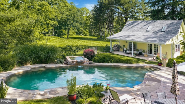 view of pool with a lawn, a patio area, an in ground hot tub, and french doors