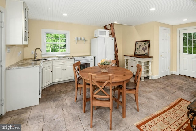 dining area featuring sink and wood ceiling