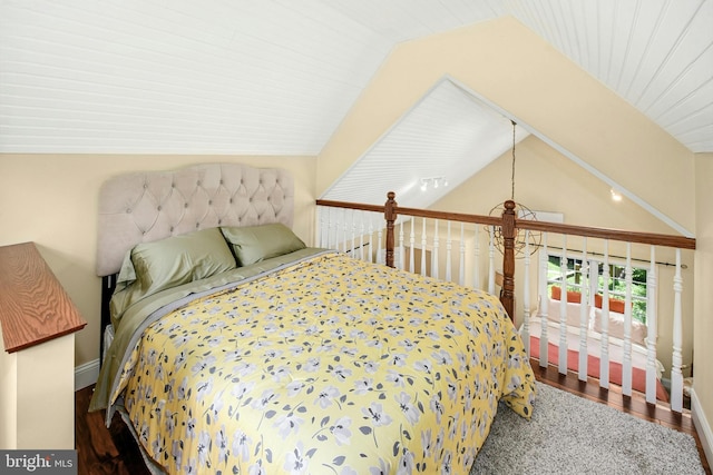 bedroom featuring wood-type flooring and vaulted ceiling