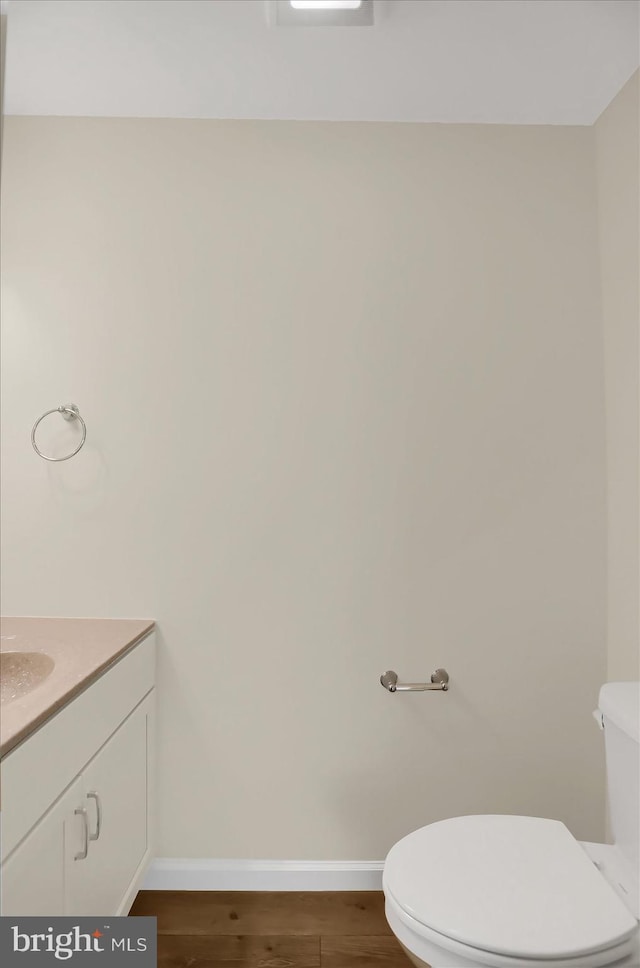 84 Limerick Ln, Selinsgrove, PA 17870 - bathroom with baseboards, toilet, wood finished floors, and vanity