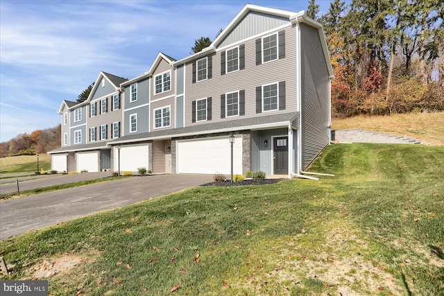 84 Limerick Ln, Selinsgrove, PA 17870 - townhome / multi-family property with driveway, a front lawn, an attached garage, and board and batten siding