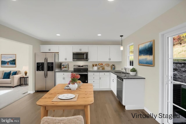 84 Limerick Ln, Selinsgrove, PA 17870 - kitchen featuring stainless steel appliances, dark countertops, a sink, dark wood-type flooring, and white cabinets