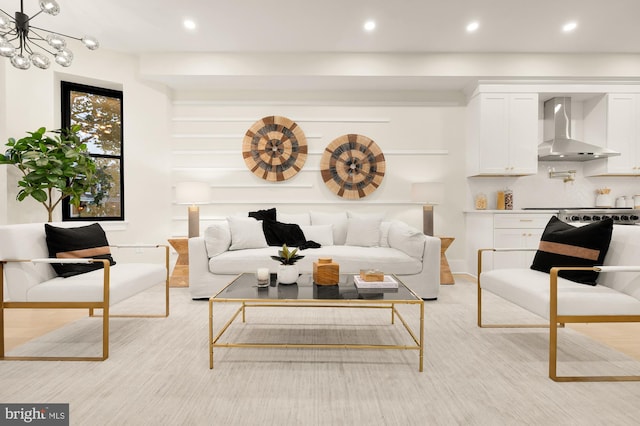 living room featuring a chandelier and light wood-type flooring