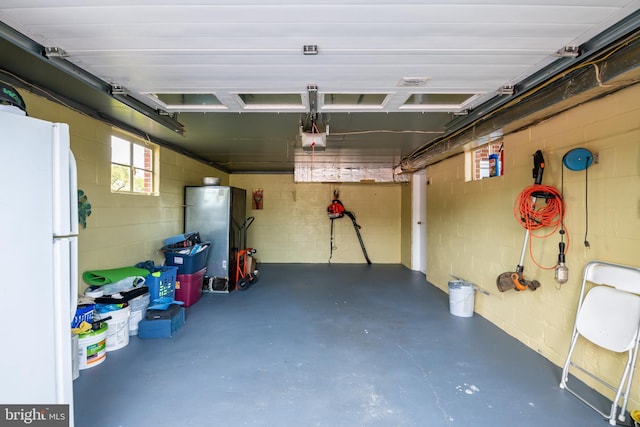 garage with white fridge and a garage door opener