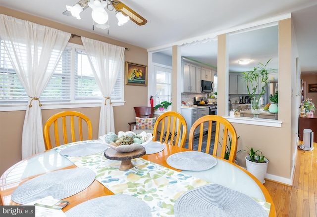 dining area featuring ceiling fan and light wood-type flooring