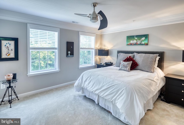 bedroom featuring ceiling fan, crown molding, and light carpet