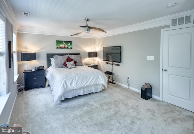 bedroom featuring ceiling fan, crown molding, and light carpet