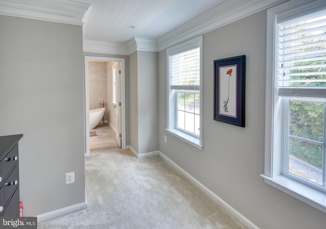 bedroom with light carpet, connected bathroom, and crown molding