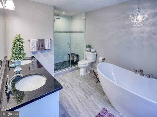 full bathroom featuring vanity, separate shower and tub, and toilet