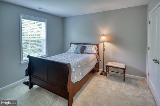 bedroom featuring light carpet