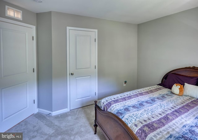 bedroom featuring light carpet