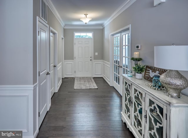 entryway with dark hardwood / wood-style floors, crown molding, and french doors