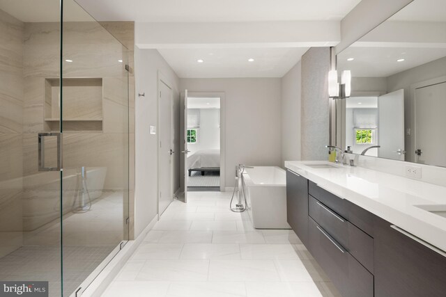 bathroom with tile patterned floors, vanity, and shower with separate bathtub