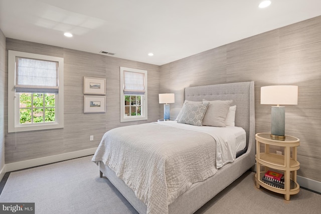 bedroom with carpet flooring and multiple windows