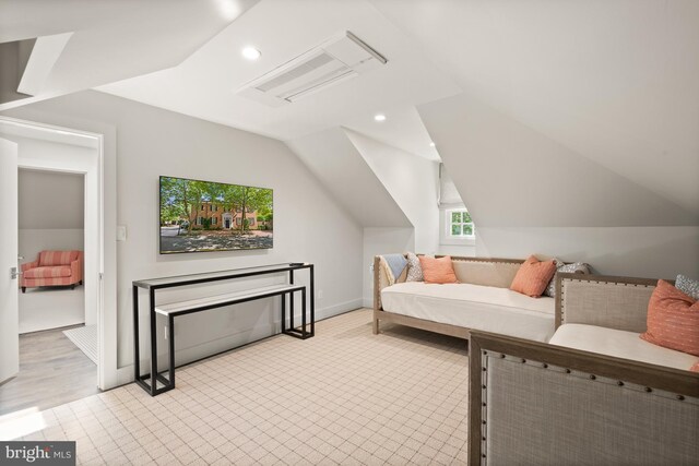 interior space featuring light hardwood / wood-style floors and vaulted ceiling