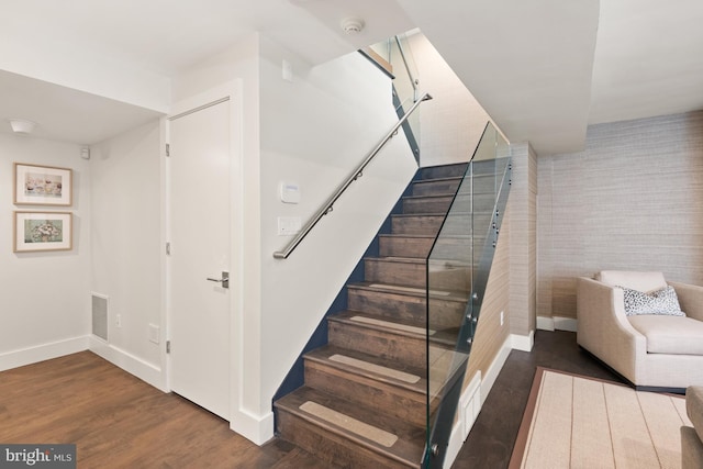 staircase featuring hardwood / wood-style floors