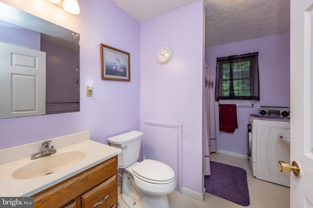 bathroom with vanity, a textured ceiling, washer / clothes dryer, and toilet